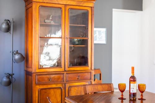 a wooden cabinet in a dining room with a table at Ambassador River Shower Suites in Lisbon