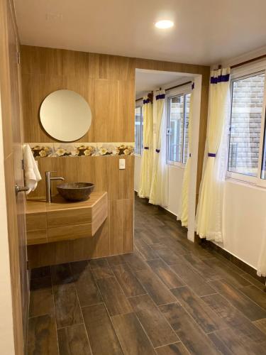 a bathroom with a sink and a mirror at Hotel & Suites Cerro Roj0 in Tlatlauquitepec