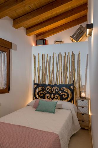 a bedroom with a bed in a room with wooden ceilings at Panorama Suite in Ávila