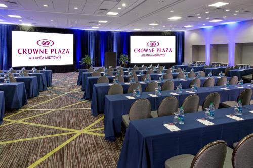 a conference room with blue tables and chairs and signs at Crowne Plaza Atlanta - Midtown by IHG in Atlanta