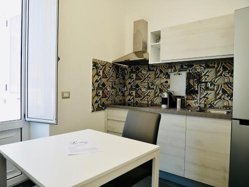 a kitchen with a white table and a counter top at "Sweet Life" Casa Vacanze in Lipari
