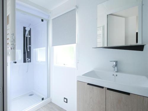a white bathroom with a sink and a shower at Les Mobil-homes By Le Marintan in Saint-Michel-de-Maurienne