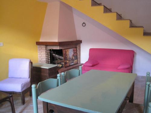 a living room with two chairs and a fireplace at Agriturismo l'Oasi in Foligno