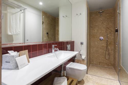 a bathroom with a sink and a toilet and a shower at NEYA Porto Hotel in Porto