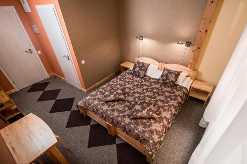 a small bedroom with a bed in a room at Abzali Hotel and Restaurant with self check-in in Ādaži