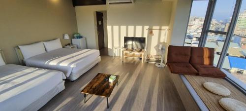 a hotel room with a bed and a couch at In Fengchia in Taichung