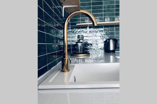 a sink with a faucet in a bathroom at Apartament z Widokiem na Morze in Gdańsk