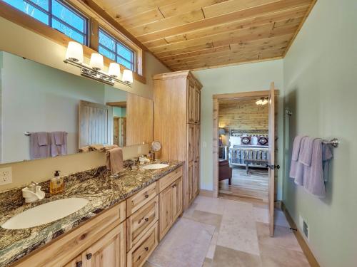 a bathroom with two sinks and a large mirror at Wee-Kin-Da-Wa in Boyne Falls