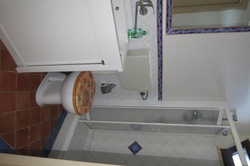a bathroom with a sink and a bath tub at Casetta Costa Turchina in Pollina