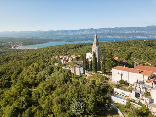an aerial view of a small town with a church at Mondinica Heritage House - Heated pool in Dobrinj