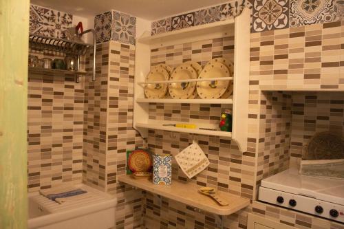 a tiled bathroom with a toilet and a sink at Casa Agrumeto 30 in Ostuni