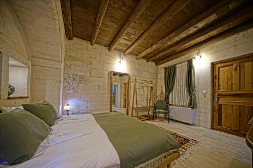a bedroom with a large bed in a room at Vigneron Cave Hotel in Nevsehir