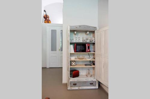 a kitchen with a cupboard filled with appliances at JaZZino in Turin