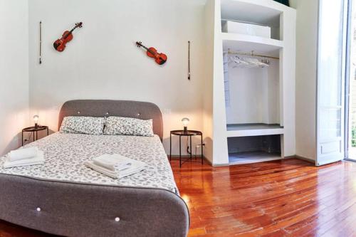 a bedroom with a bed with a guitar on the wall at JaZZino in Turin