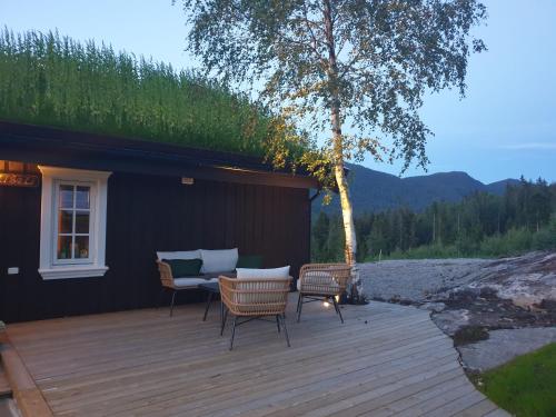 a deck with chairs and a couch on a house at Libeli Panorama in Lona