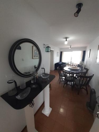 a bathroom with a mirror on a counter and a table at Al Mar in Piriápolis