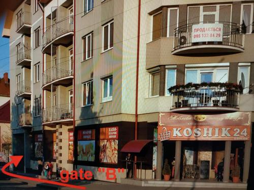 a tall building with a sign on the side of it at Wonderful Panoramic View Apartment in Mukacheve