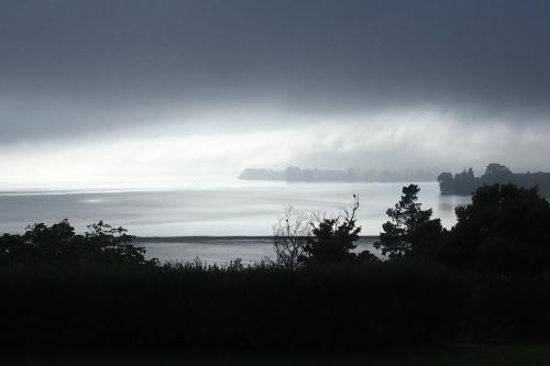 a view of a body of water on a cloudy day at Mangawhai Bay B&B in Omokoroa