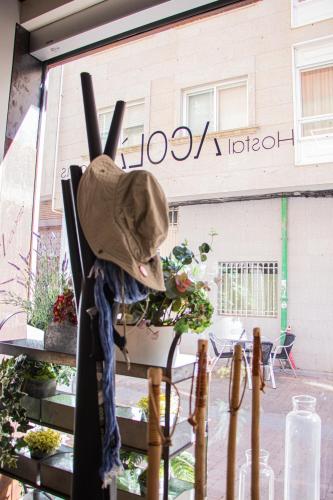 a hat hanging on a fence in front of a building at Acolá Rooms in Pontevedra