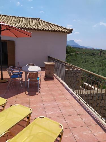 a patio with chairs and a table and a grill at Markos apartments 3 in Stoupa
