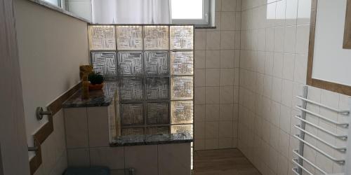 a shower with a glass door in a bathroom at Mohnblume, die kleine Oase in Möhnesee