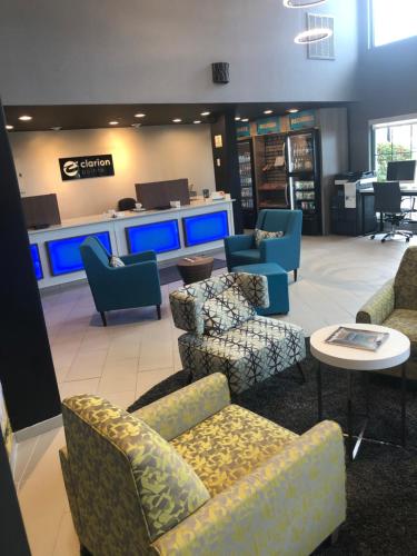 a waiting room with couches and chairs in a store at Clarion Pointe Indianapolis Airport in Plainfield