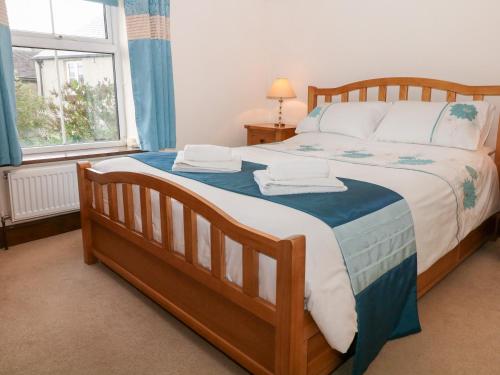 a bedroom with a large bed with towels on it at Field View in Bradwell
