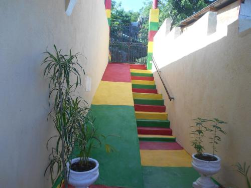 a stairway with a rainbow painted on it with plants at Solet's Paradise Negril in Negril