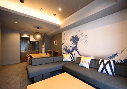 a living room with a couch and a table at Minn Ueno in Tokyo