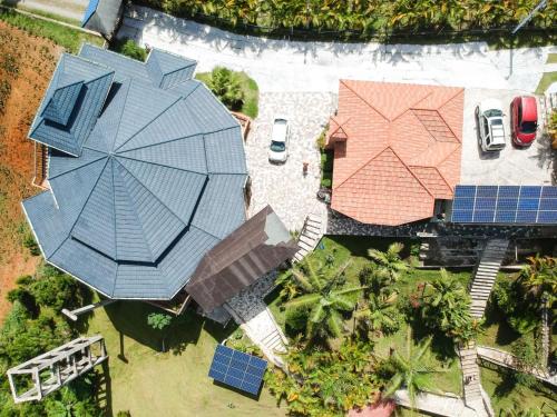 an overhead view of a house with an umbrella and solar panels at Villas Las Neblinas in Constanza