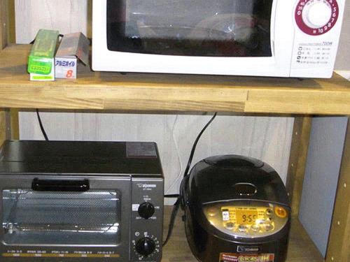a microwave and a toaster oven sitting on a shelf at Field Hakone Resort in Hakone