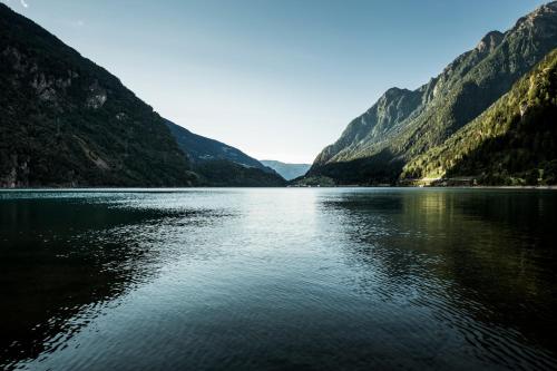 a view of a lake in the middle of mountains at Raselli Sport Hotel in Le Prese, Poschiavo