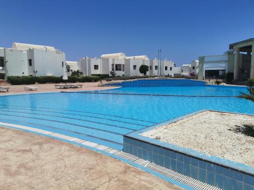 a large swimming pool in front of some buildings at Chic Apartment 2 in Sharm El Sheikh