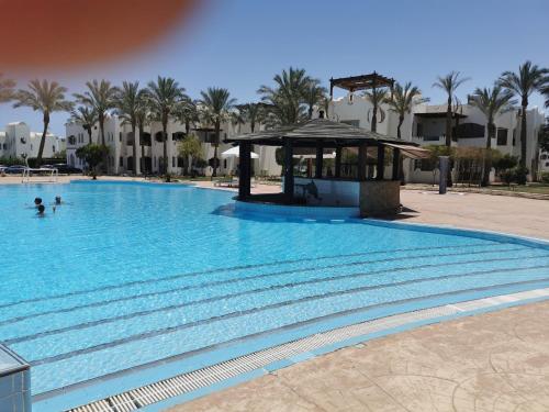 a large swimming pool with a gazebo at Chic Apartment 2 in Sharm El Sheikh