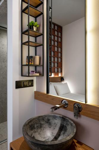 a bathroom with a sink and a mirror at Camere Maritima in Chania Town