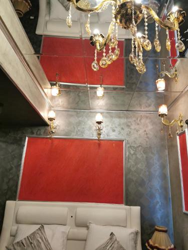 a room with a bed and a chandelier at Chic Apartment 2 in Sharm El Sheikh