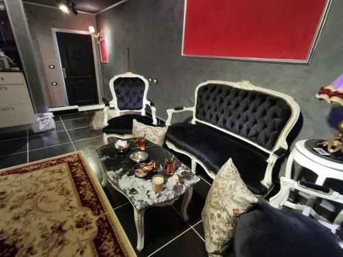 a living room with two chairs and a table at Chic Apartment 2 in Sharm El Sheikh