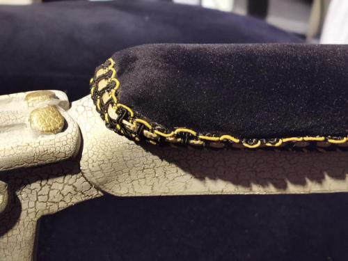 a black purse with a gold chain on a couch at Chic Apartment 2 in Sharm El Sheikh