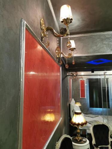 a room with a red door and a lamp at Chic Apartment 2 in Sharm El Sheikh
