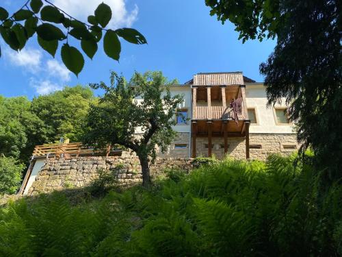 a house with a deck on top of a stone wall at Luxusboofe - Ferienhaus am Lilienstein in Königstein an der Elbe