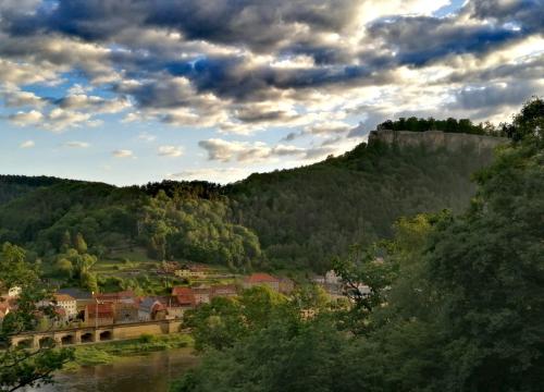 a town on a hill with a river and a bridge at Luxusboofe - Ferienhaus am Lilienstein in Königstein an der Elbe