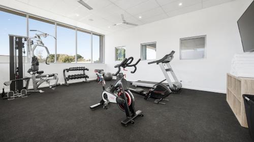 a gym with bikes and exercise equipment in a room at Oaks Toowoomba Hotel in Toowoomba