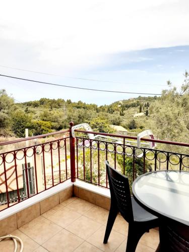 a balcony with a table and chairs and a view at Monika Lefkada in Tsoukaladhes