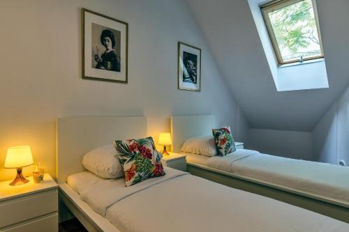 En eller flere senge i et værelse på Galeria Italiana Apartments