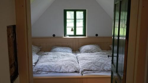 a bed in a room with a window at STEYR RIVER LODGE in Hinterstoder