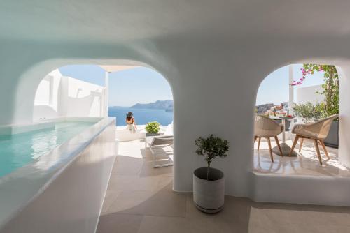a house with a swimming pool and a view of the ocean at Aspaki by Art Maisons in Oia
