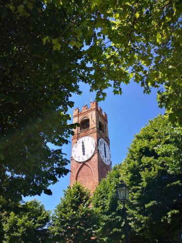 a tall brick clock tower with a clock on it at Park Hotel in Mondovì