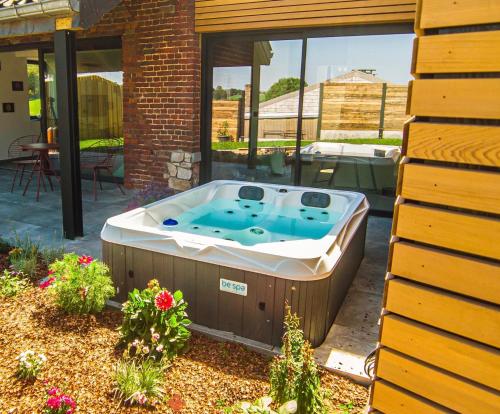 a hot tub in the backyard of a house at Les gîtes de Bouxhmont in Herve