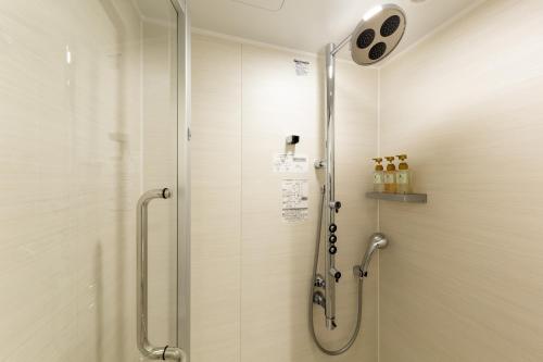 a shower with a glass door in a bathroom at The OneFive Kyoto Shijo in Kyoto