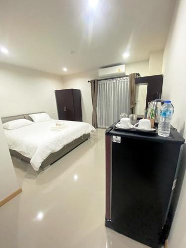 a bedroom with a bed and a table with water bottles at Re Riva in Ban Bang Bamru